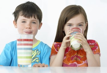 Boy and Girl Drinking Milk Shakes