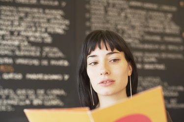 Portrait of a young woman holding a mobile phone