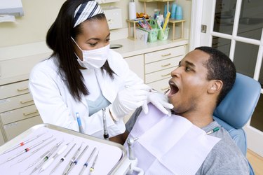 Dentist examining patient
