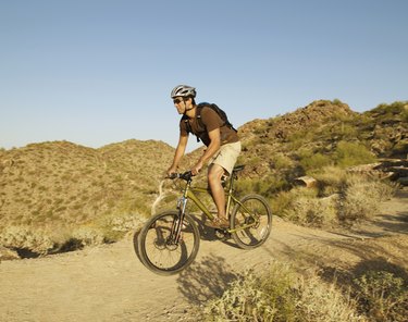 Hispanic man riding bicycle