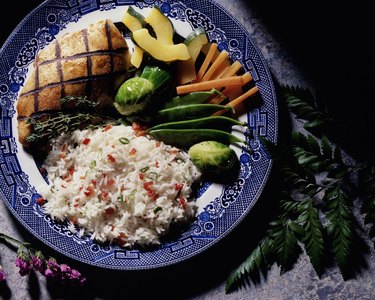 Grilled fish served with rice and vegetables