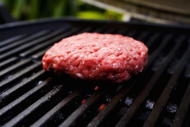 Barbecue scene, hamburger patty on the grill.