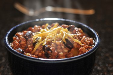 Chili con carne with cheese in a bowl