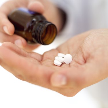 close-up of tablets in the palm of a hand