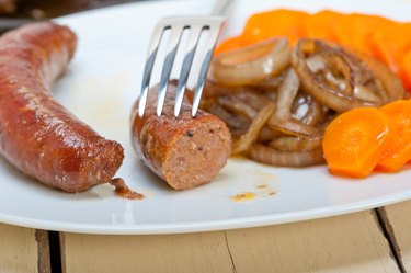 beef sausages cooked on iron skillet