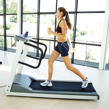 young woman jogging on a treadmill