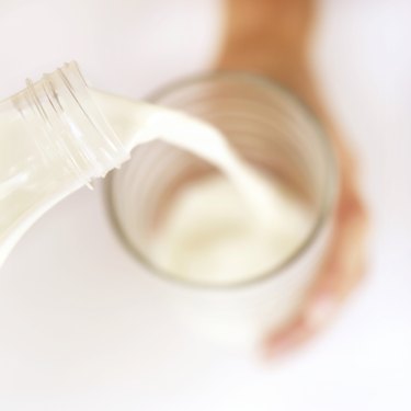 close-up of milk pouring into a glass