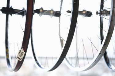 Row of spoked bicycle wheels in bicycle shop