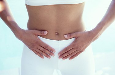 Woman with hands on abdomen