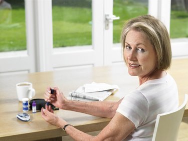 Woman using glucometer for diabetes