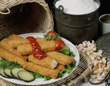 Fried fish sticks with sauce in a plate