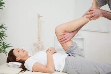 Serious brunette woman lying on a medical table