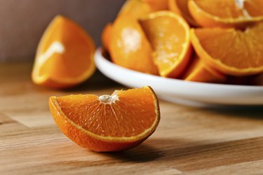 cut tangerines on wooden table