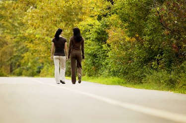 Two women are walking together outside