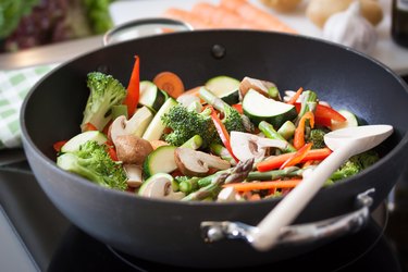 Wok stir fry vegetables with zucchini, spring asparagus, paprika