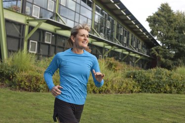 Fit Mature Woman Running Near Office Building