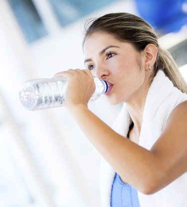 Gym woman drinking water