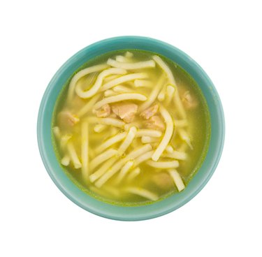 Chicken noodle soup in a green bowl