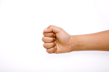 Close-up of child's hand playing Rock Paper Scissors