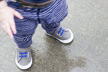 overhead view of toddler wearing tennis shoes demonstrating the right size toddler shoes