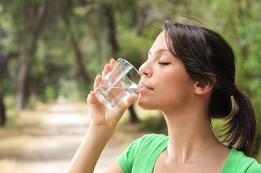 woman drinking water glass