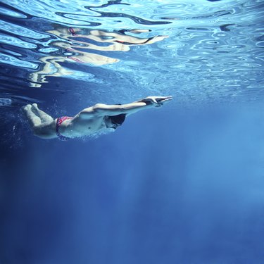 professional swimmer underwater swimming butterfly