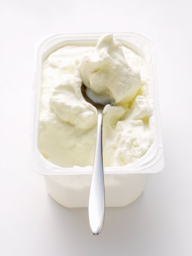 Cottage cheese in white bowl with spoon