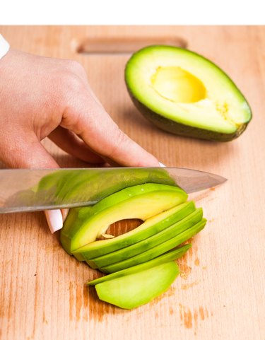 slicing fresh avocado close-up