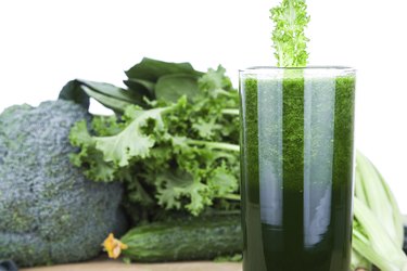 Green vegetable juice isolated on white background