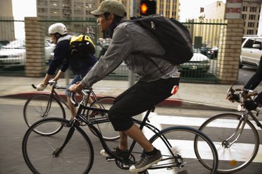 Men riding bicycles on city street