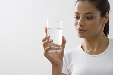 Young woman holding glass of water