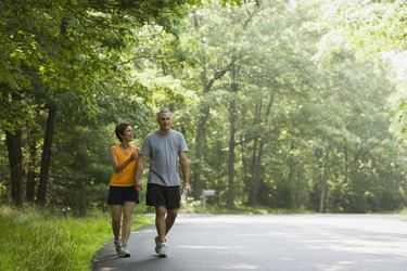 Happy couple walking along road together