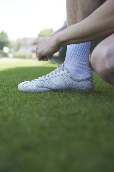 Close up of a person tying the laces on their running shoes