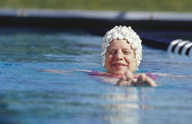 Woman swimming in pool, surface view
