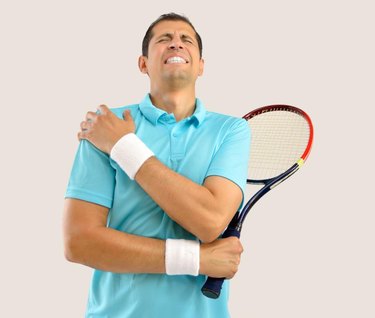 Shot of a tennis player with a shoulder injury over white background