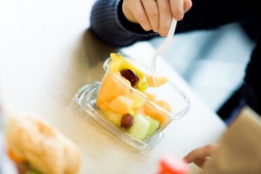 Person eating fresh fruit