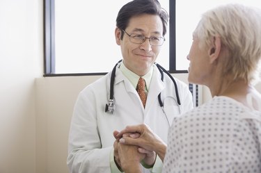 Doctor and patient with hands clasped