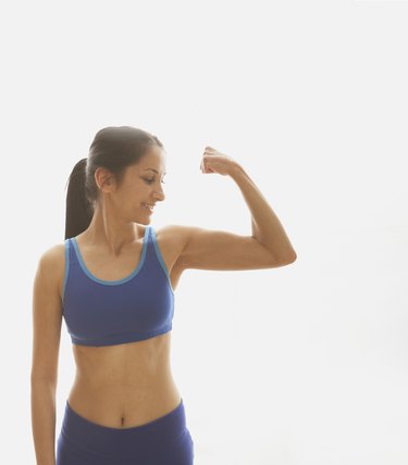 Young woman flexing her muscles