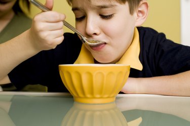 Boy eating at table