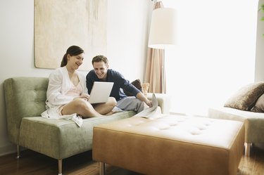 Smiling couple looking at laptop computer