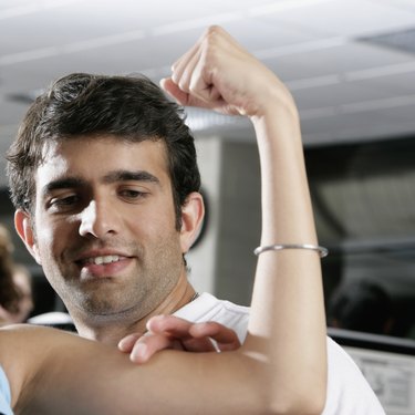 Close-up of a young man touching a woman's bicep
