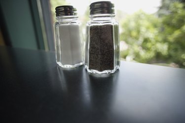 close up of salt and pepper shakers on a table
