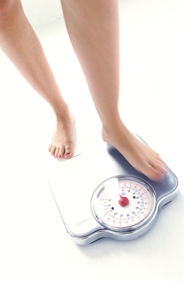 high angle view of woman's feet on a weighing scale
