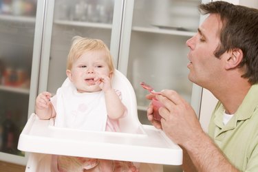 Father feeding baby