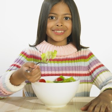 Hispanic girl eating salad