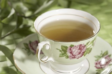 Close-up of a cup of green tea on a saucer