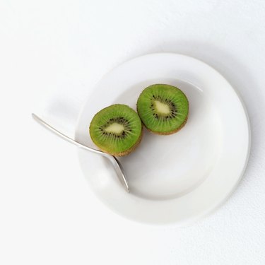 sliced kiwi on a plate with a fork