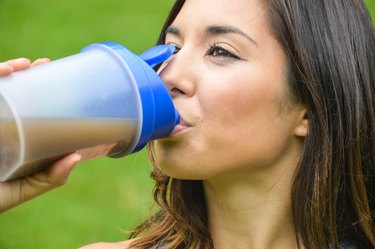 Woman drinking a meal replacement shake (protein shake)