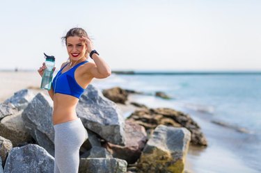 Woman working out outdoors in the summer at the beachWoman working out outdoors in the summer at the beach