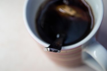 Metal Spoon in Cup of Brewed Tea